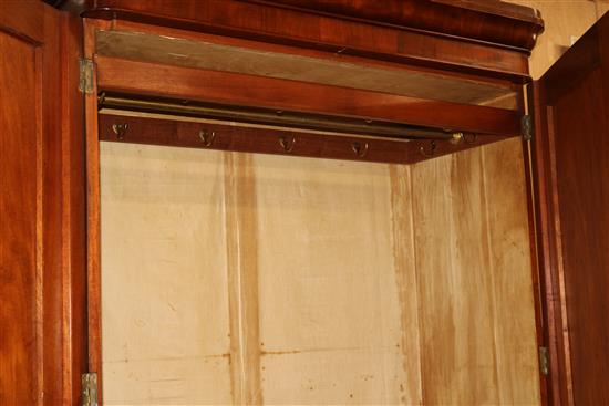 A Victorian mahogany wardrobe, with moulded cornice, fitted two panelled doors and with a drawer below, W.3ft 8in., H.204cm
